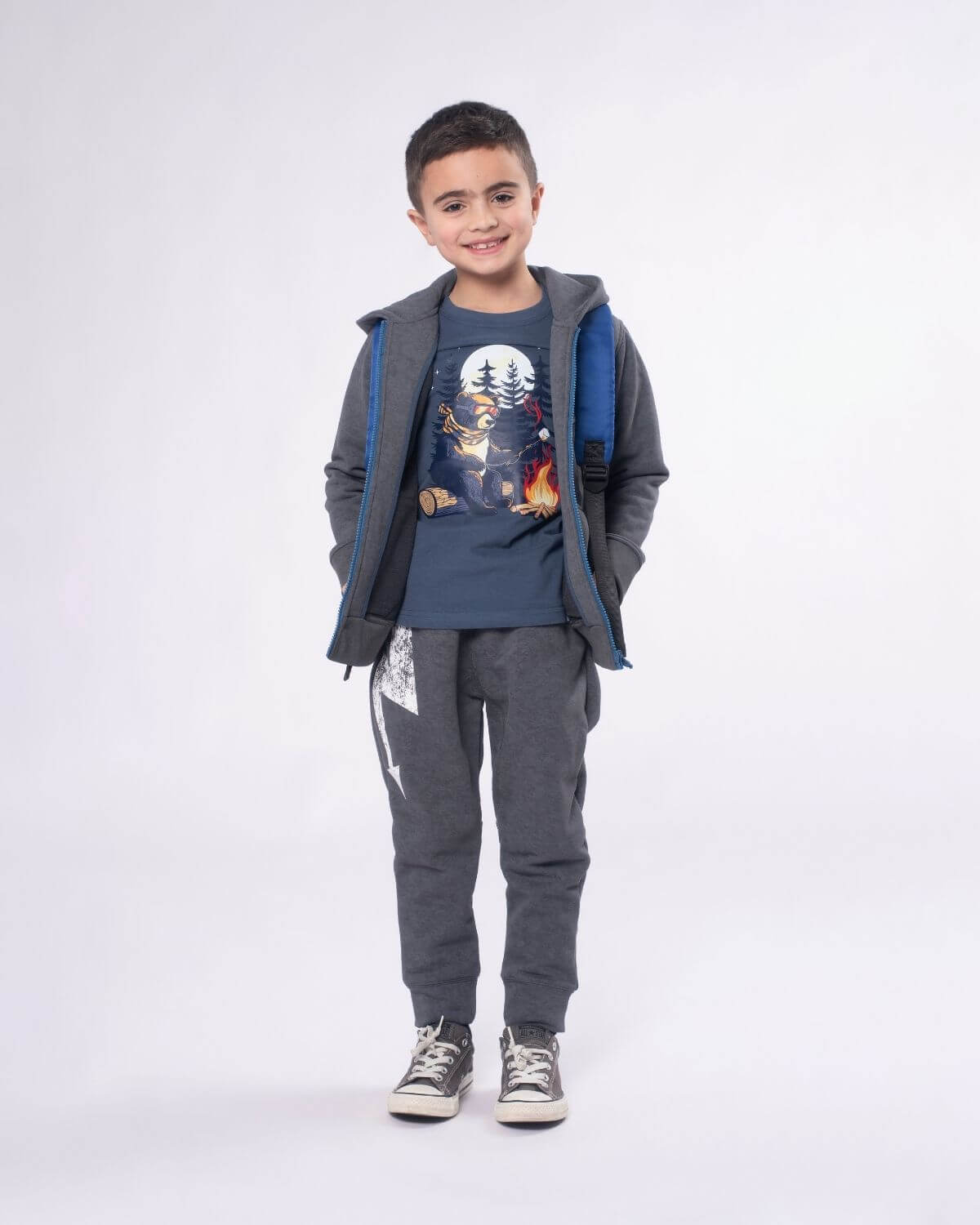 Stylish kid in a washed grey hoodie, graphic tee, and sweatpants ready for back to school adventures. High-quality kids clothes.