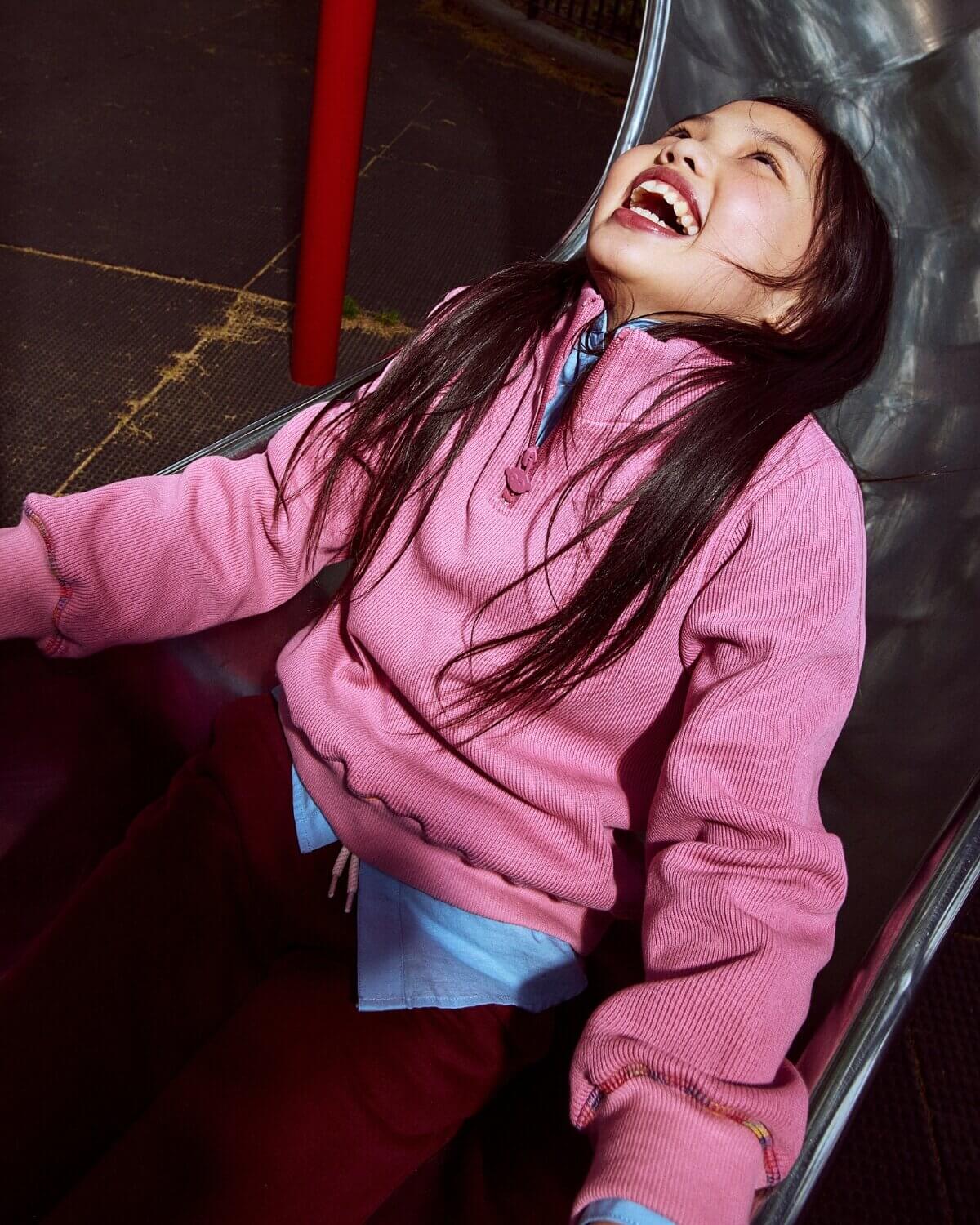 Person wearing a pink jacket with a blurred background