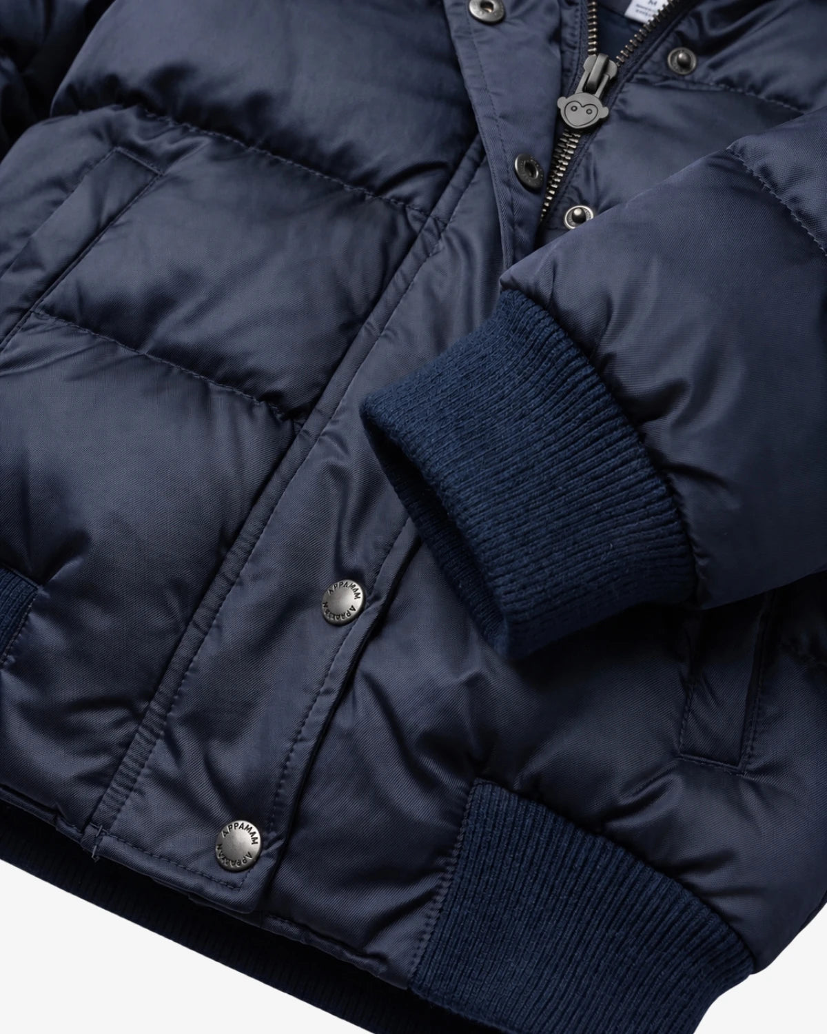 Appaman girls' navy puffer bomber jacket, close-up cuff snap detail.