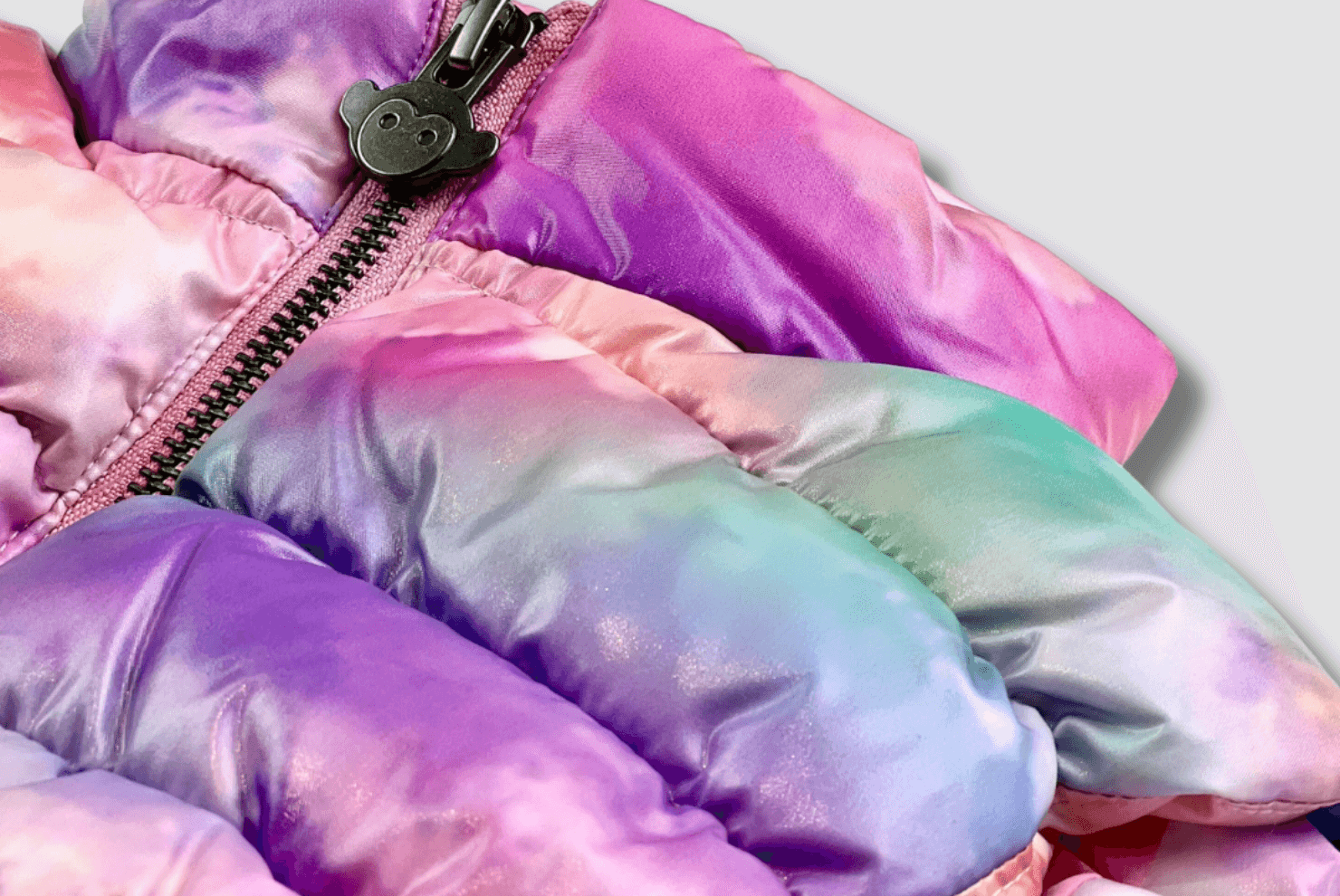 Vibrant tie-dye puffer jacket detail, perfect for stylish kids' winter adventures.