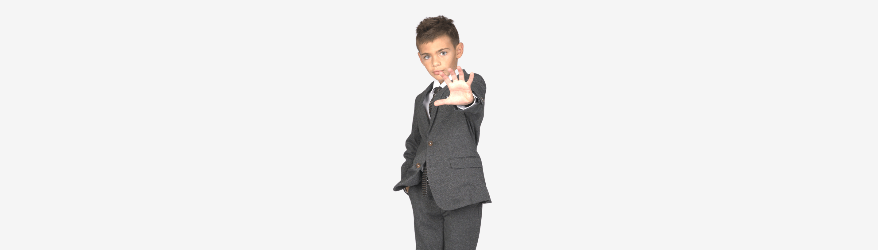 Stylish boy in a tailored suit, exuding confidence and flair for kids' formal wear.