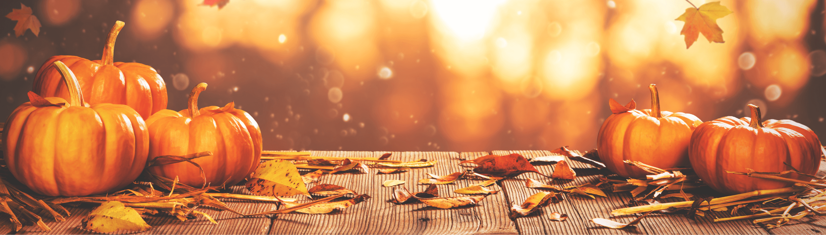 A festive autumn scene with vibrant pumpkins and colorful fallen leaves, perfect for a cozy Halloween vibe.