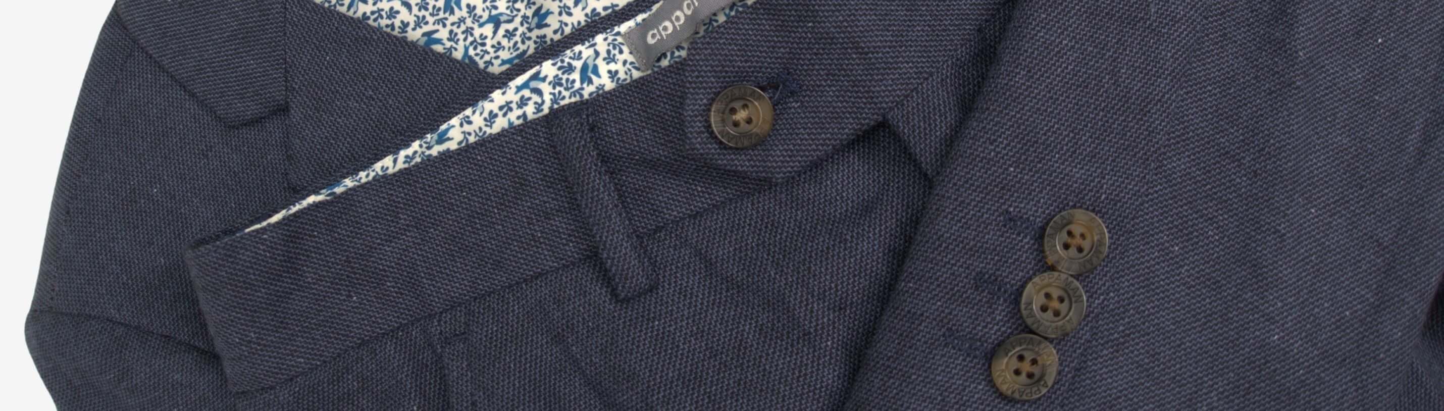 Stylish navy linen suit with playful patterned lining, perfect for kids’ spring celebrations and elegant outings.