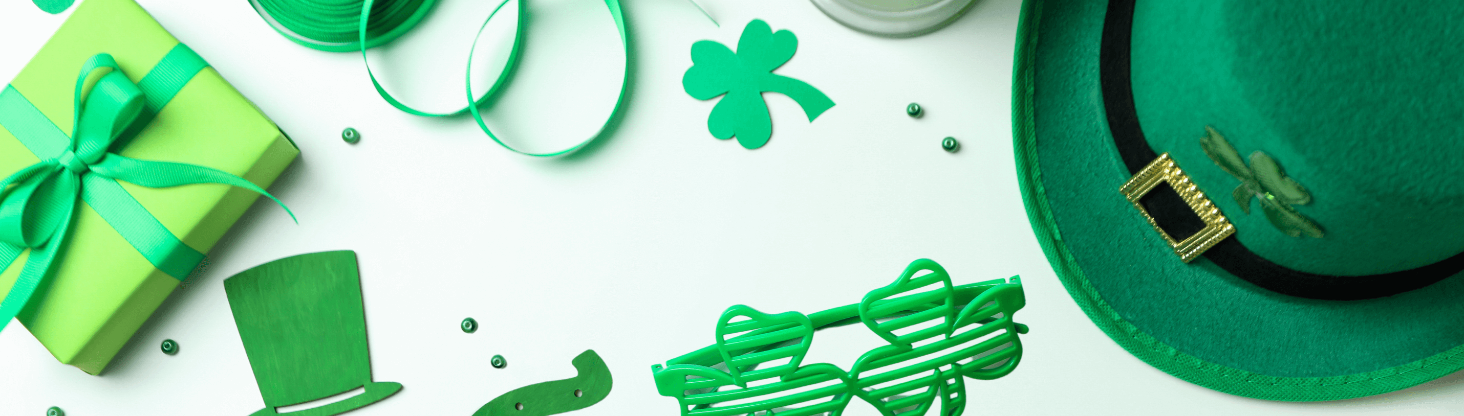 Vibrant St. Patrick's Day decor with green hat, shamrock, gift, and fun accessories for kids' celebrations.