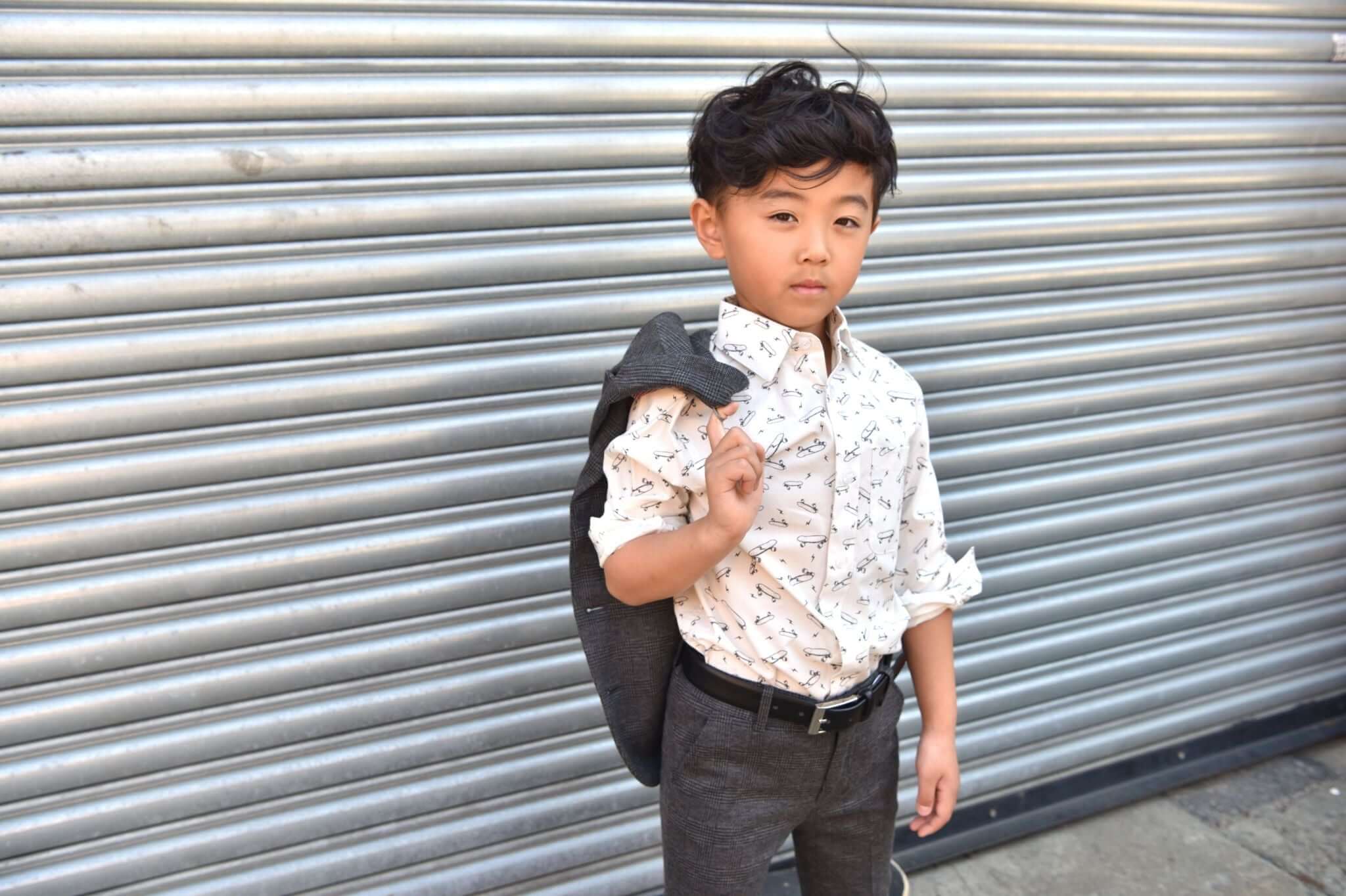 Stylish boy in a patterned shirt and blazer, ready to shine on Sunday mornings with Appaman's chic boys' clothing.