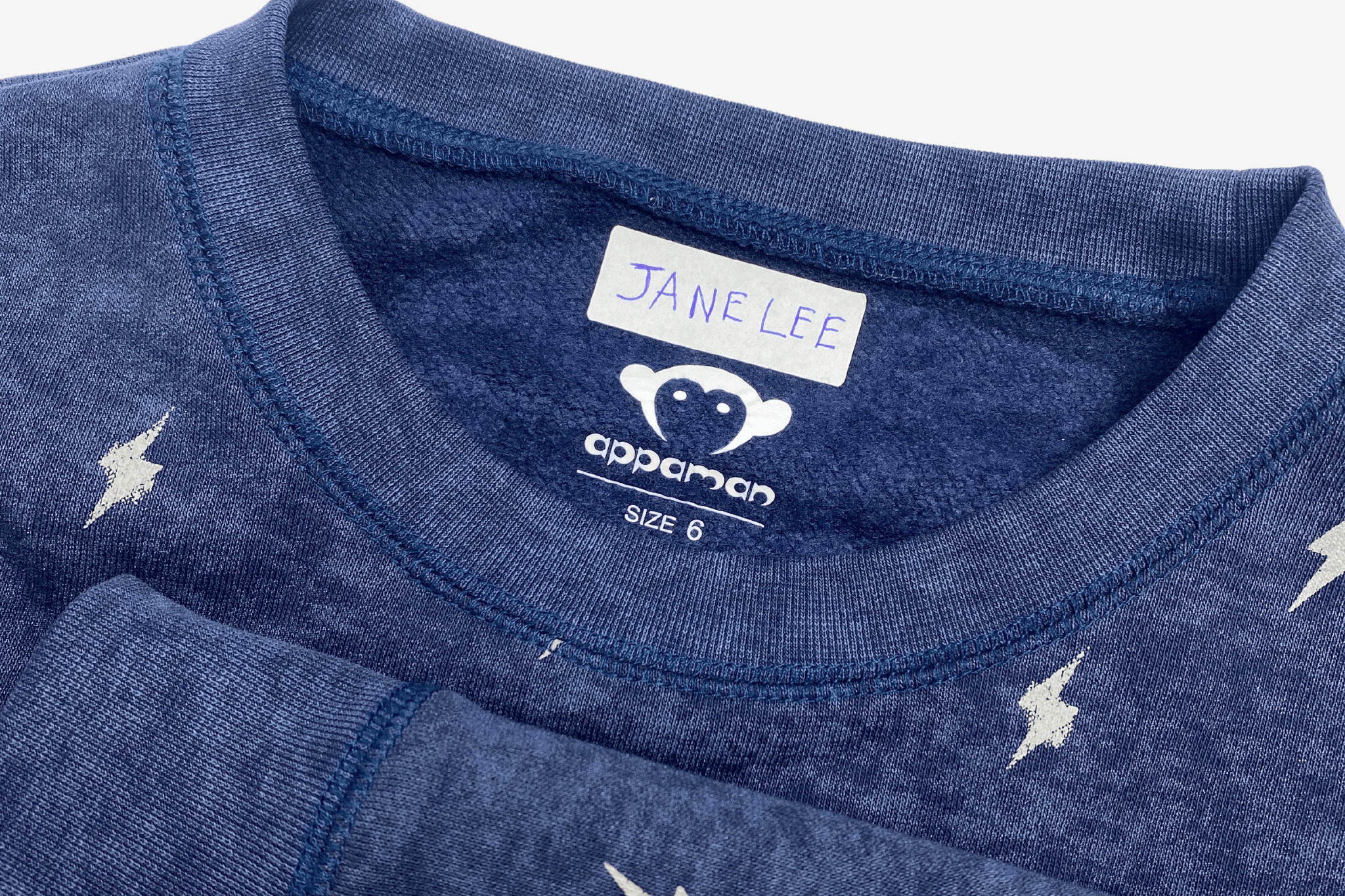 Close-up of an Appaman kids' shirt with a label reading 'Jane Lee'—stylish and ready for adventure!