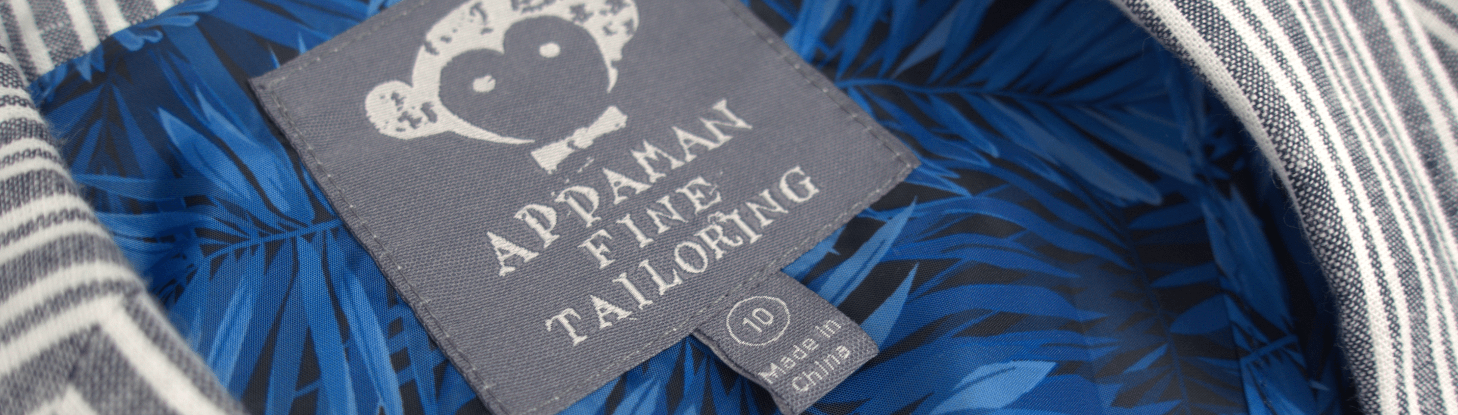 Appaman's stylish label showcasing fine tailoring details and vibrant blue lining in a kids' linen suit.