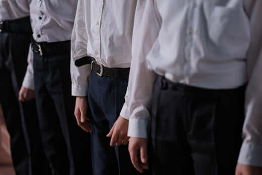 Boys in stylish dress shirts and tailored pants, showcasing modern kids fashion for formal occasions.