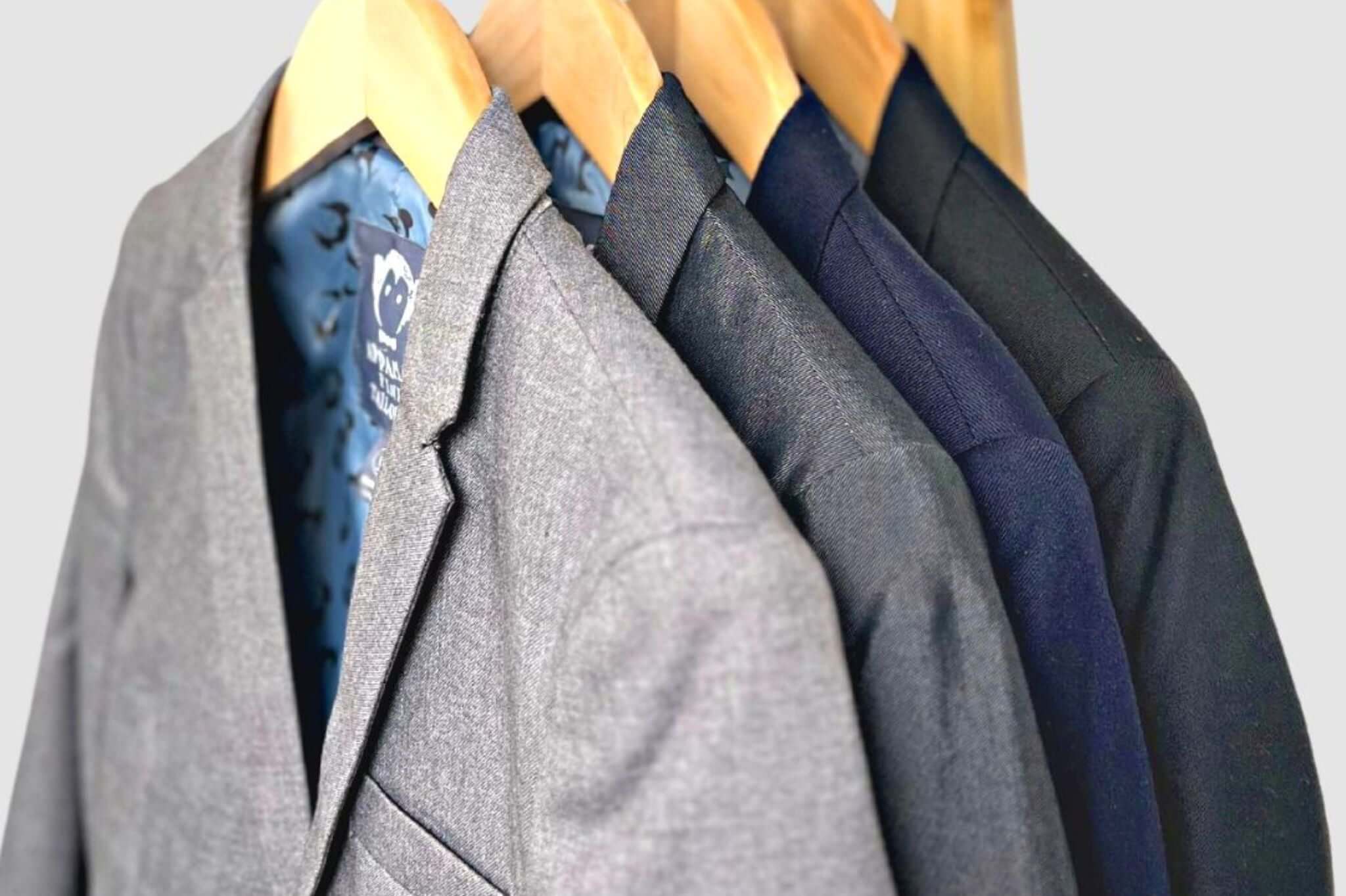 Stylish collection of Appaman boys suits hanging on wooden hangers, showcasing fine tailoring and modern designs.