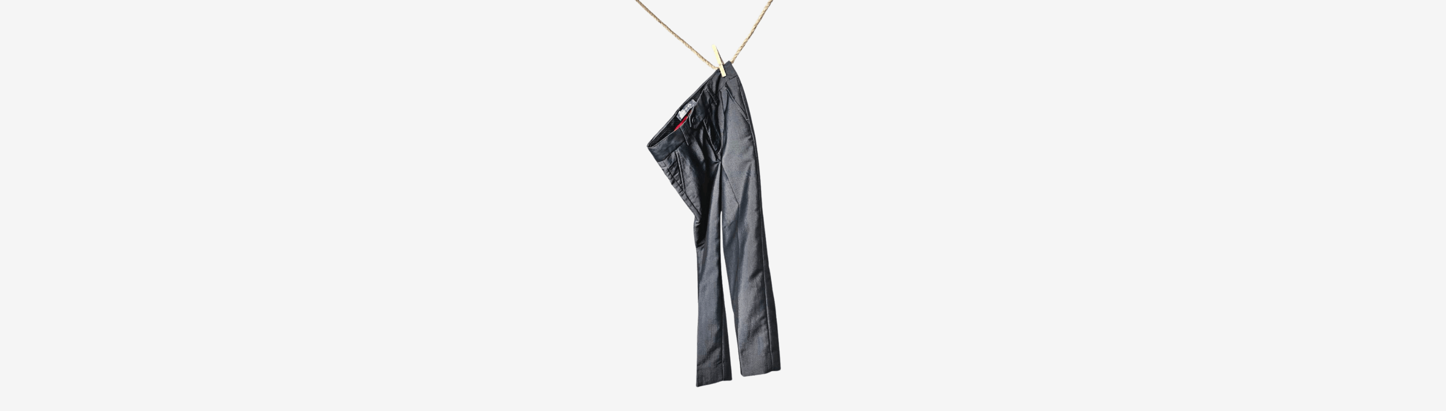 Stylish black kids' pants hanging playfully, ideal for trendy boys' outfits and versatile kids styling tips.