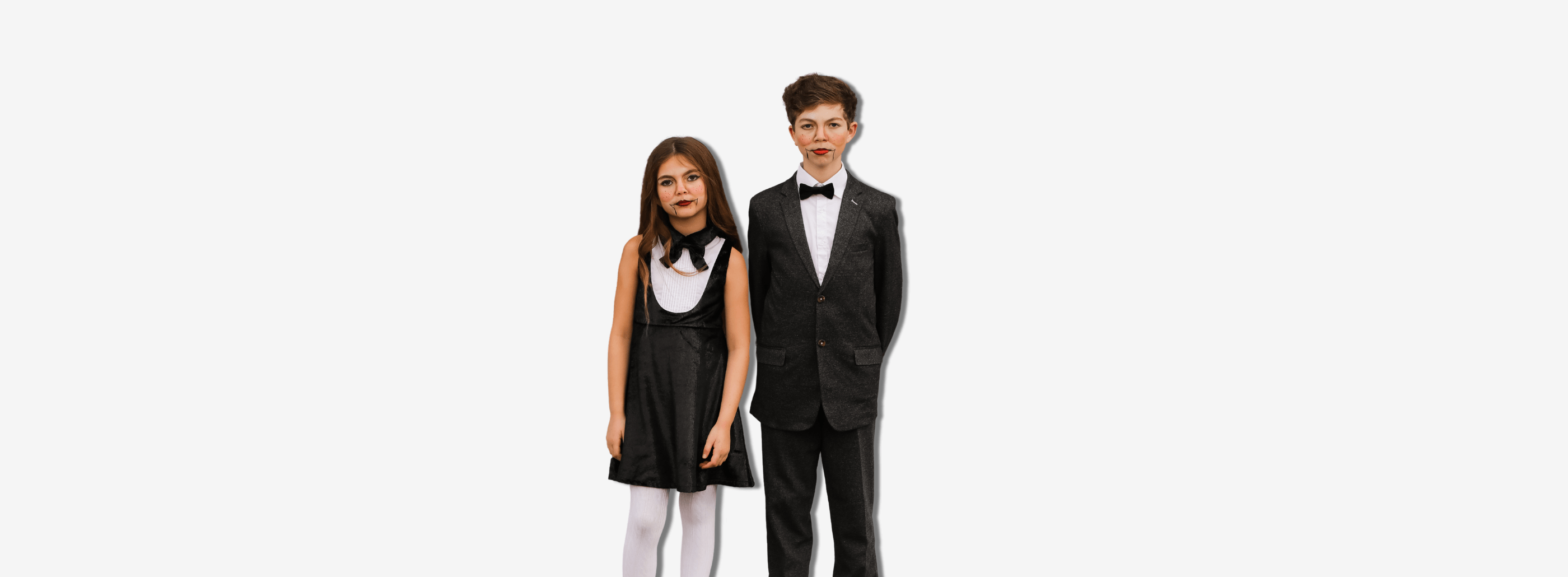 Stylish kids in chic black costumes, showcasing modern Halloween looks for boys and girls. Perfect for last-minute ideas!