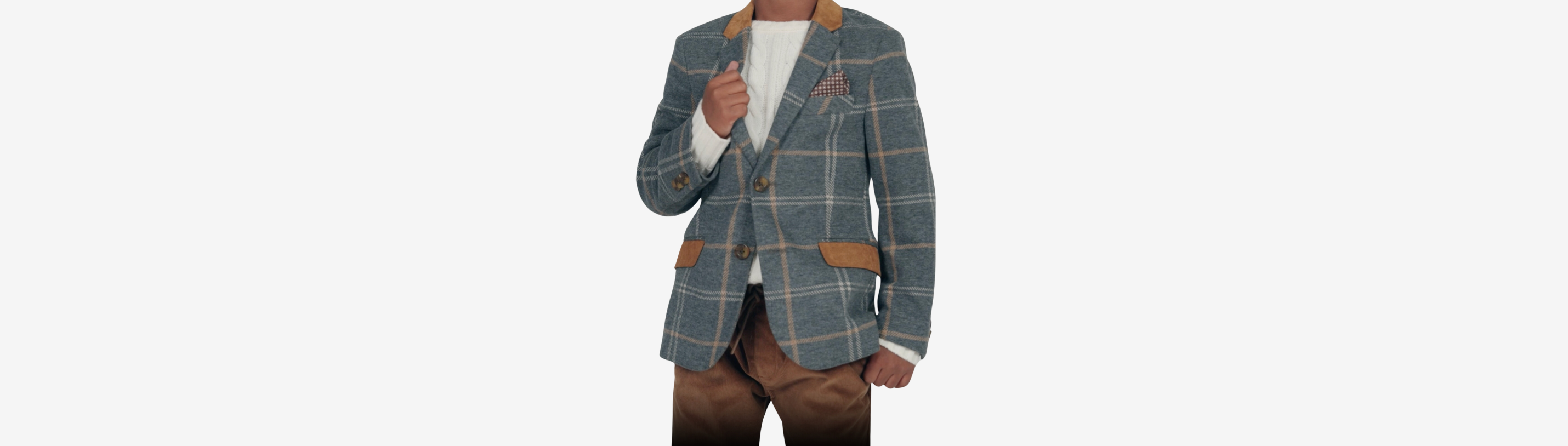 Stylish boy in a checked suit jacket, effortlessly blending casual and chic for a trendy look.