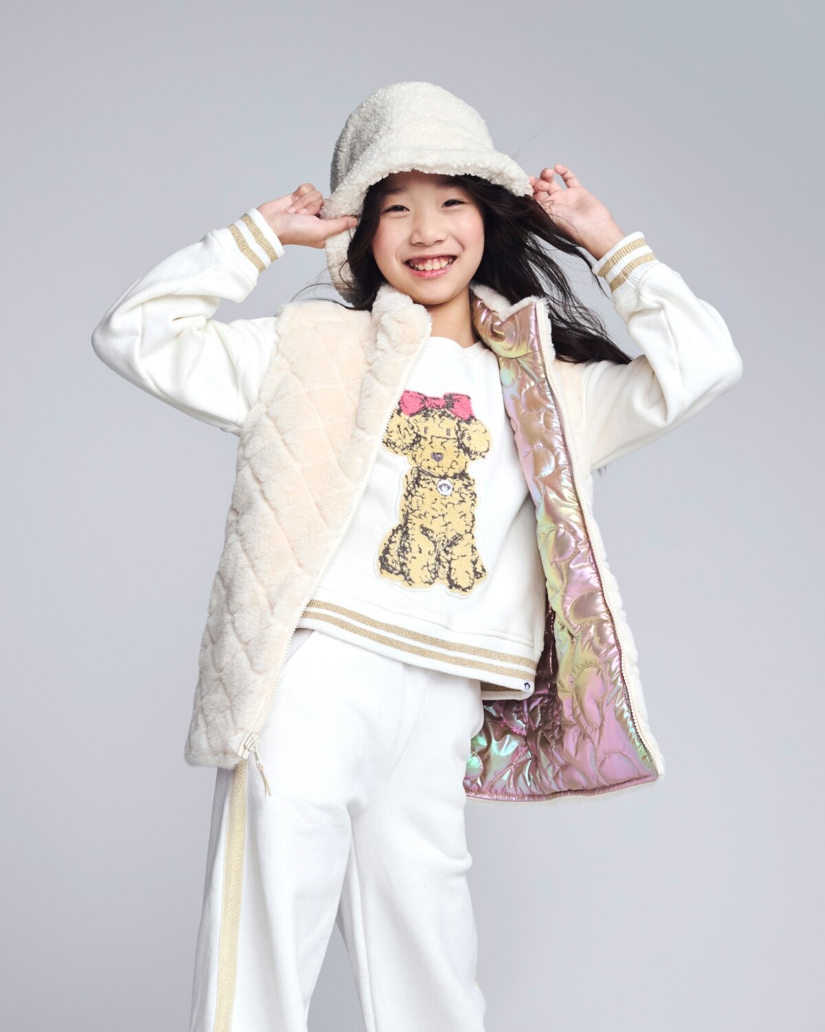 Girl wearing a stylish pink corduroy jacket from the Girls' Jackets & Vests collection.