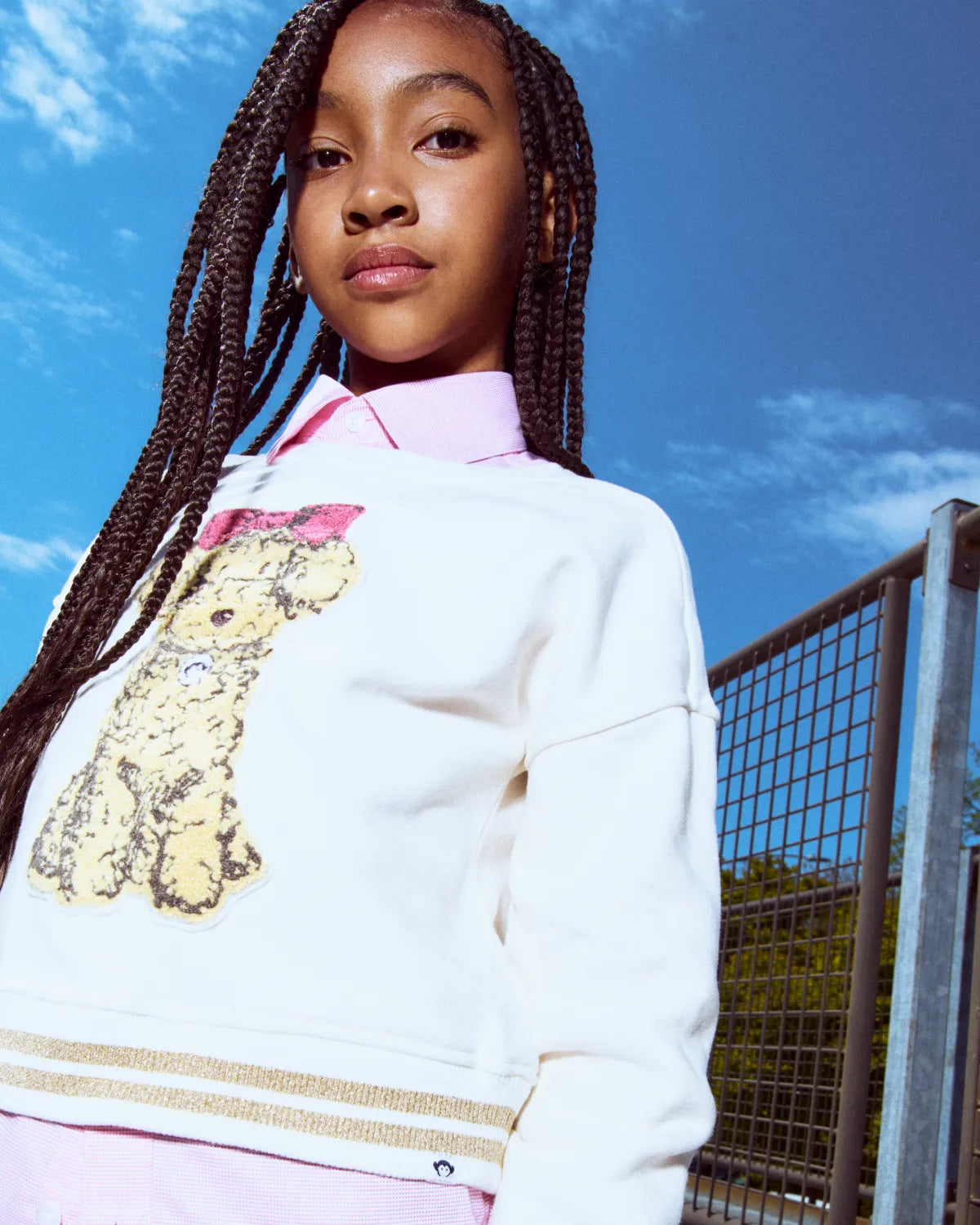 A young girl wearing a pink corduroy jacket, skirt, and brown boots, showcasing Girls' New Arrivals.