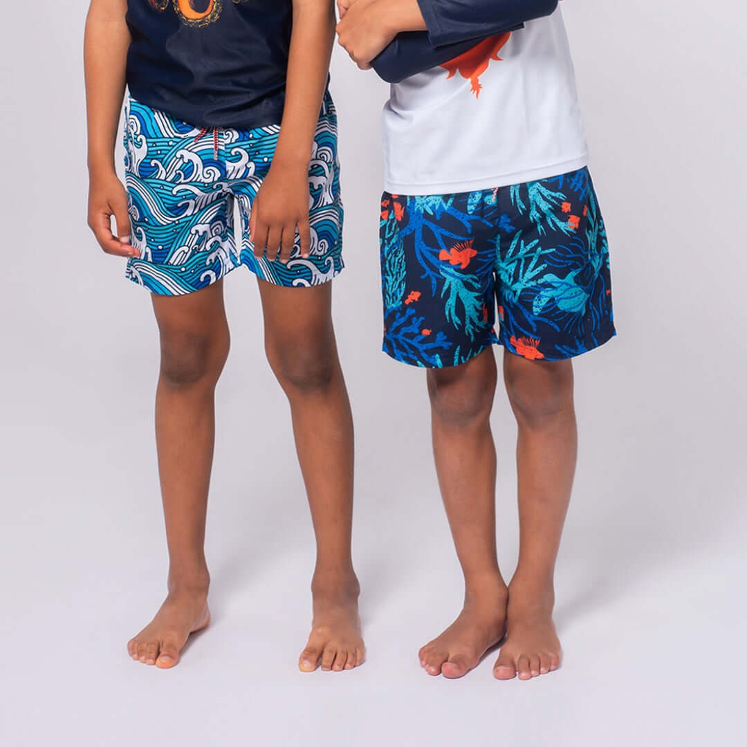 Two boys showcasing vibrant Appaman swim trunks, ready for summertime splashes and adventures by the water.