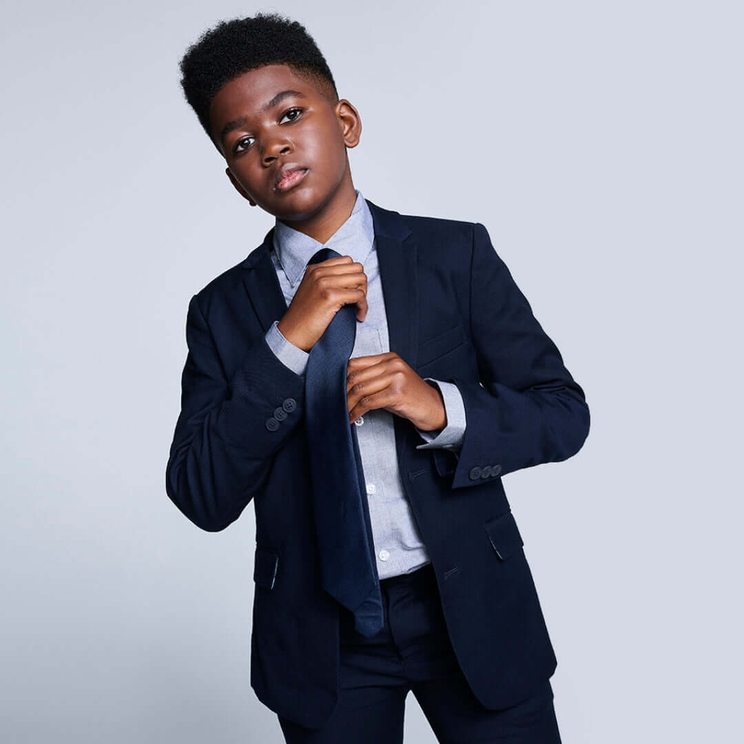 Boys' Ties stylishly complementing a little boy's suit in smart attire.