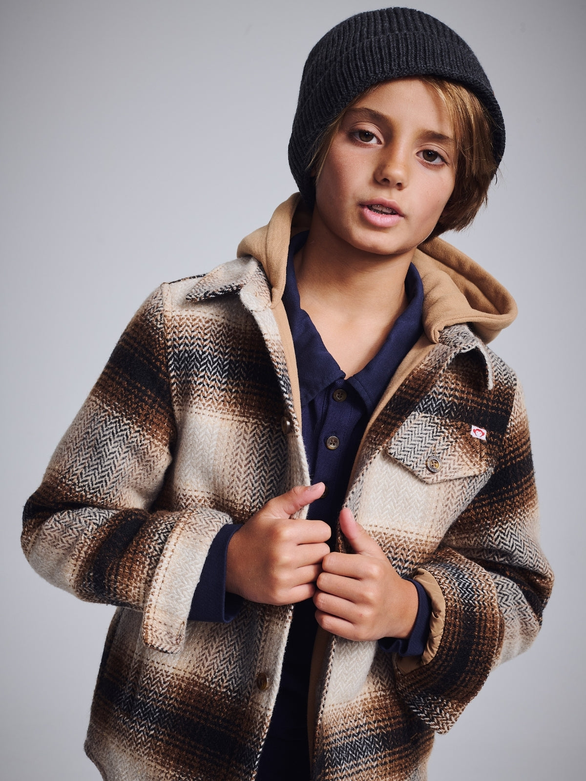 Cool boy in a vibrant tropical shirt, ready for adventures in stylish and durable kids clothing.