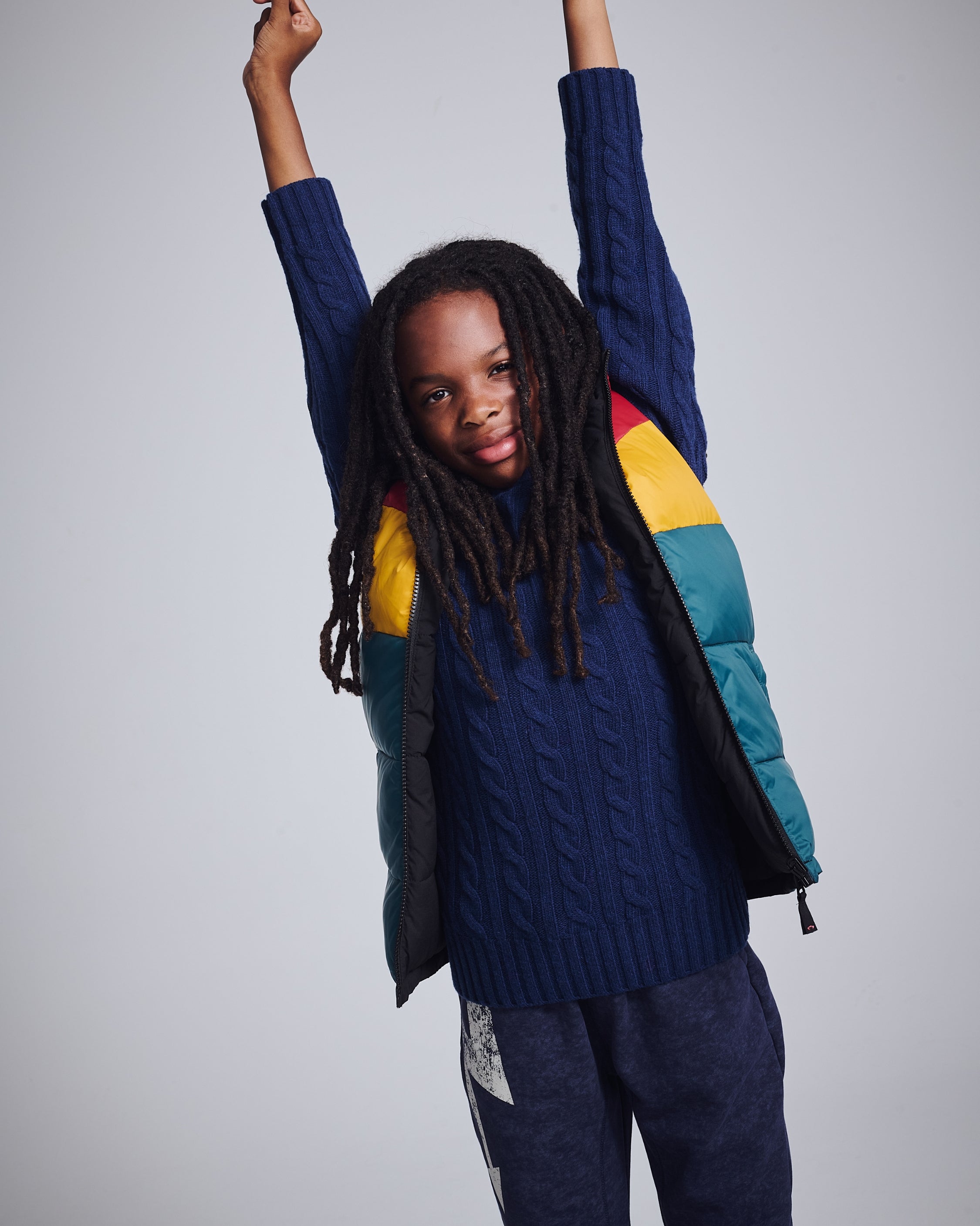 Stylish boy in a cozy gray striped sweater, perfect for keeping warm and looking sharp this sweater season.