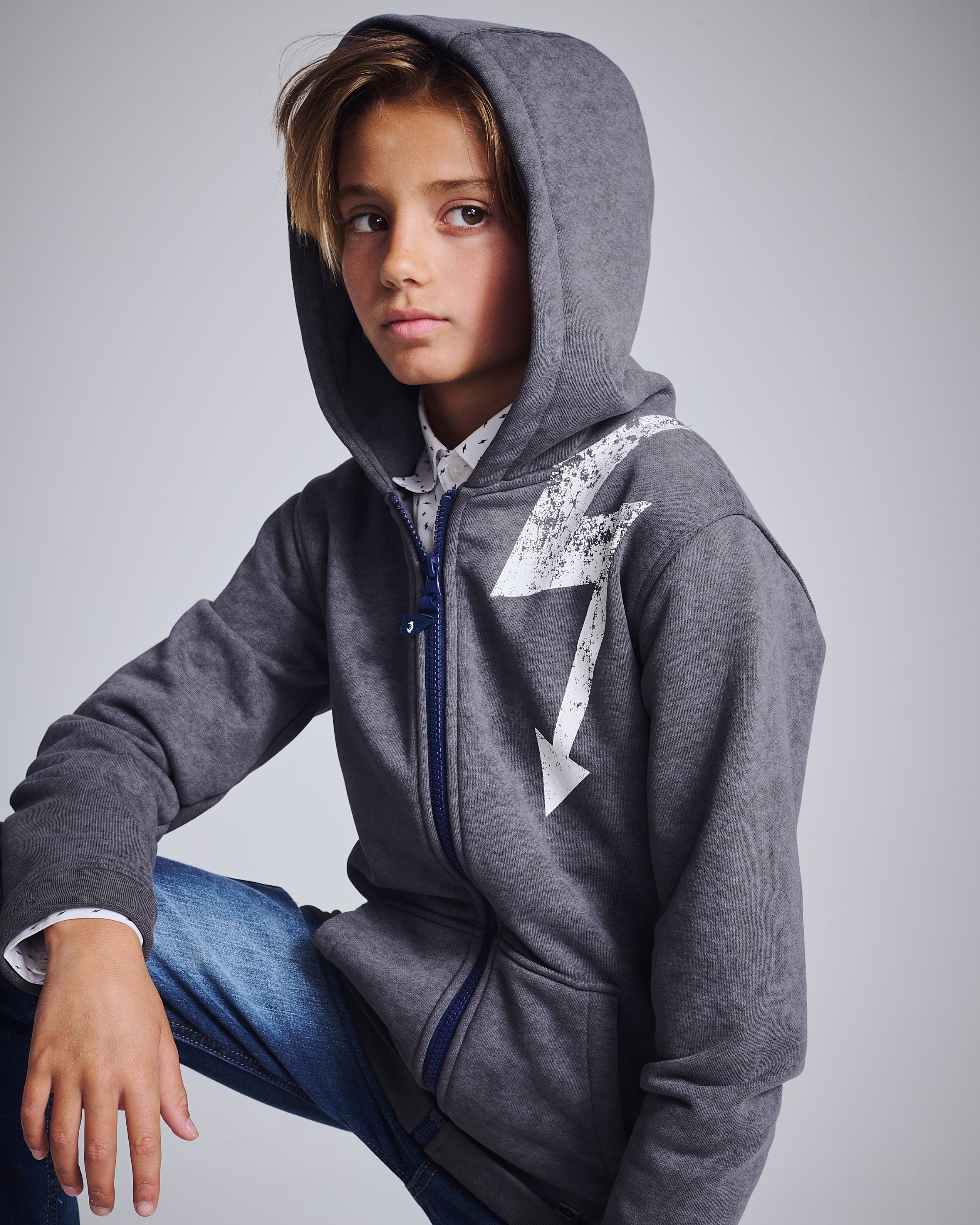 A cheerful boy showcasing a trendy tie-dye hoodie, blending comfort and style for the modern kid.