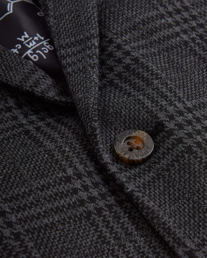 Close-up of the Gentleman's Plaid Stretchy Mod Suit, showcasing the stylish button and grey plaid fabric.