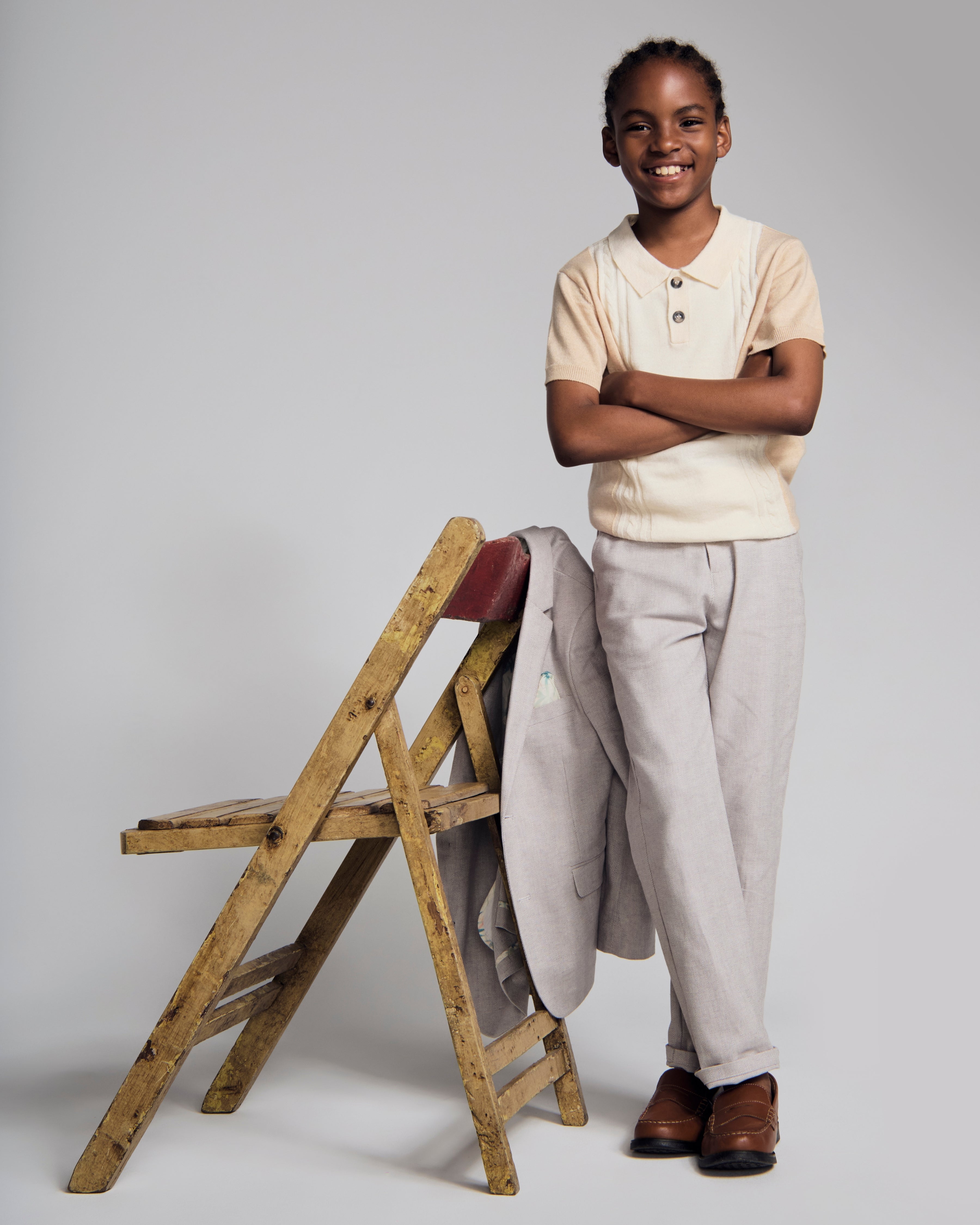 Beige Sweater Knit Polo worn by a child, showcasing a collared design and stylish casual attire.
