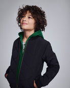 Black BX Bomber jacket on a child with a green hood, showcasing a stylish and functional look.