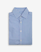 Folded blue and white striped shirt on a light gray background