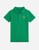 Green polo shirt with a palm tree design on a white background
