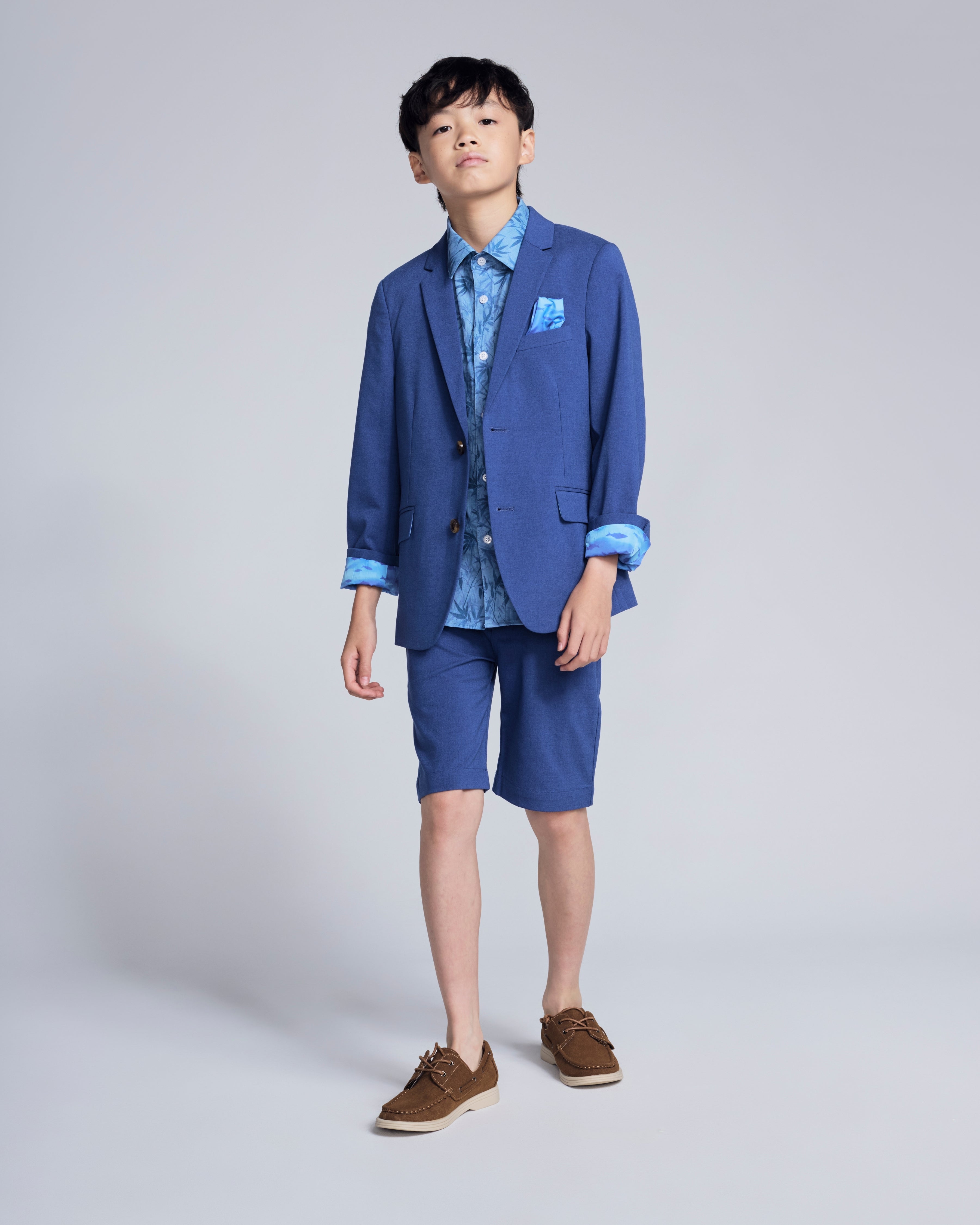 Boy wearing Canopy Blue Trouser Short and matching jacket, showcasing polished summer style and comfort.