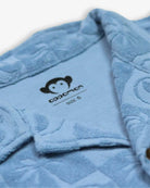 Cozy blue terry shirt collar with playful palm tree design by Appaman, ideal for stylish kids' adventures.