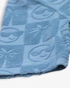 Denim blue resort shirt detail featuring palm trees and smiley faces—fun kids clothes for trendy summer vibes!