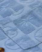 Close-up of our Blue Resort Terry Shirt's textured fabric featuring playful palm tree patterns. Stylish kids' clothing!