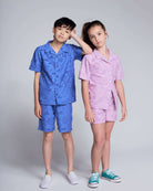 Two kids wearing Cobalt Blue Terry Resort Shirt and matching shorts, showcasing summer style with collared design.