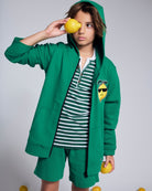 Cool Lemon Strivers Hoodie worn by a child holding a lemon, featuring a cool lemon graphic patch and a zip-up design.