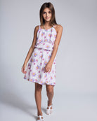 Girl wearing the Daisies Leah Layered Dress with floral print and adjustable tie straps.