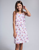 Girl wearing the Daisies Leah Layered Dress with floral print and layered details, perfect for sunny days.
