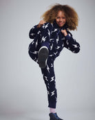 Child wearing the Electrifying Fleece Sweatsuit Set with lightning bolt design, striking a playful pose.