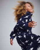 Child wearing the Electrifying Fleece Sweatsuit Set with bold lightning bolt print, showcasing comfort and style.