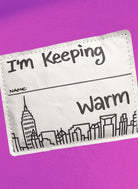 Label with 'I'm Keeping Warm' text and cityscape design on a purple background
