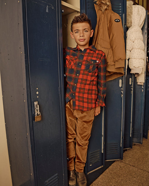 a boy standing in a locker