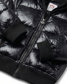 Shiny Black Flurry Coat featuring shiny insulation and ribbed cuffs for extra warmth and style.