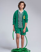 Garden Green Stripe Hilltop Henley worn with green shorts and hoodie, perfect for spring layering.