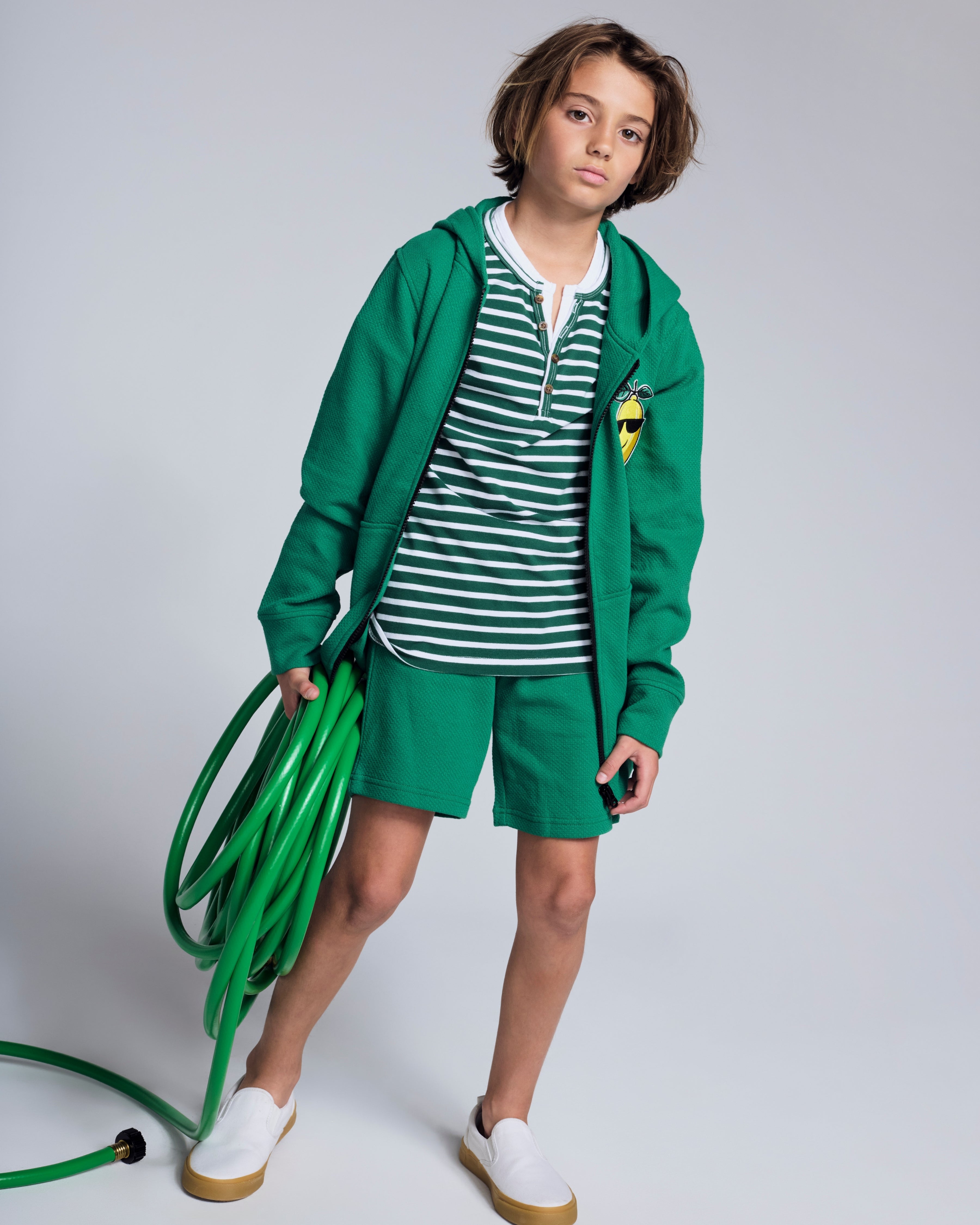 Garden Green Stripe Hilltop Henley styled with a green hoodie and shorts, ideal for casual spring outings.