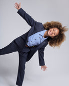 A joyful child wearing a stylish Glacier Lake Beach Shirt with a suit, showcasing playful summer fashion.
