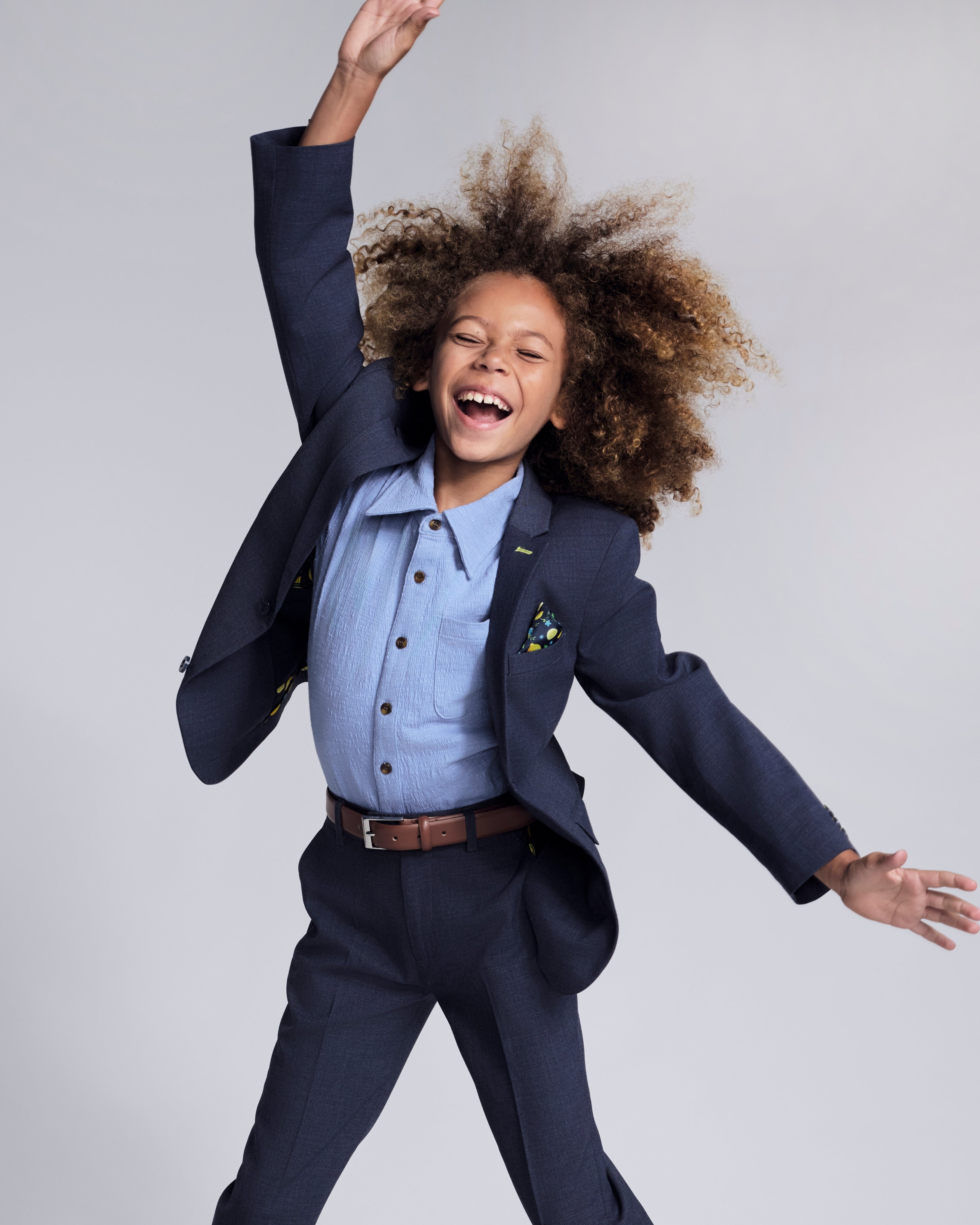 Happy child wearing Glacier Lake Beach Shirt with a suit, showcasing fun and effortless kids style.