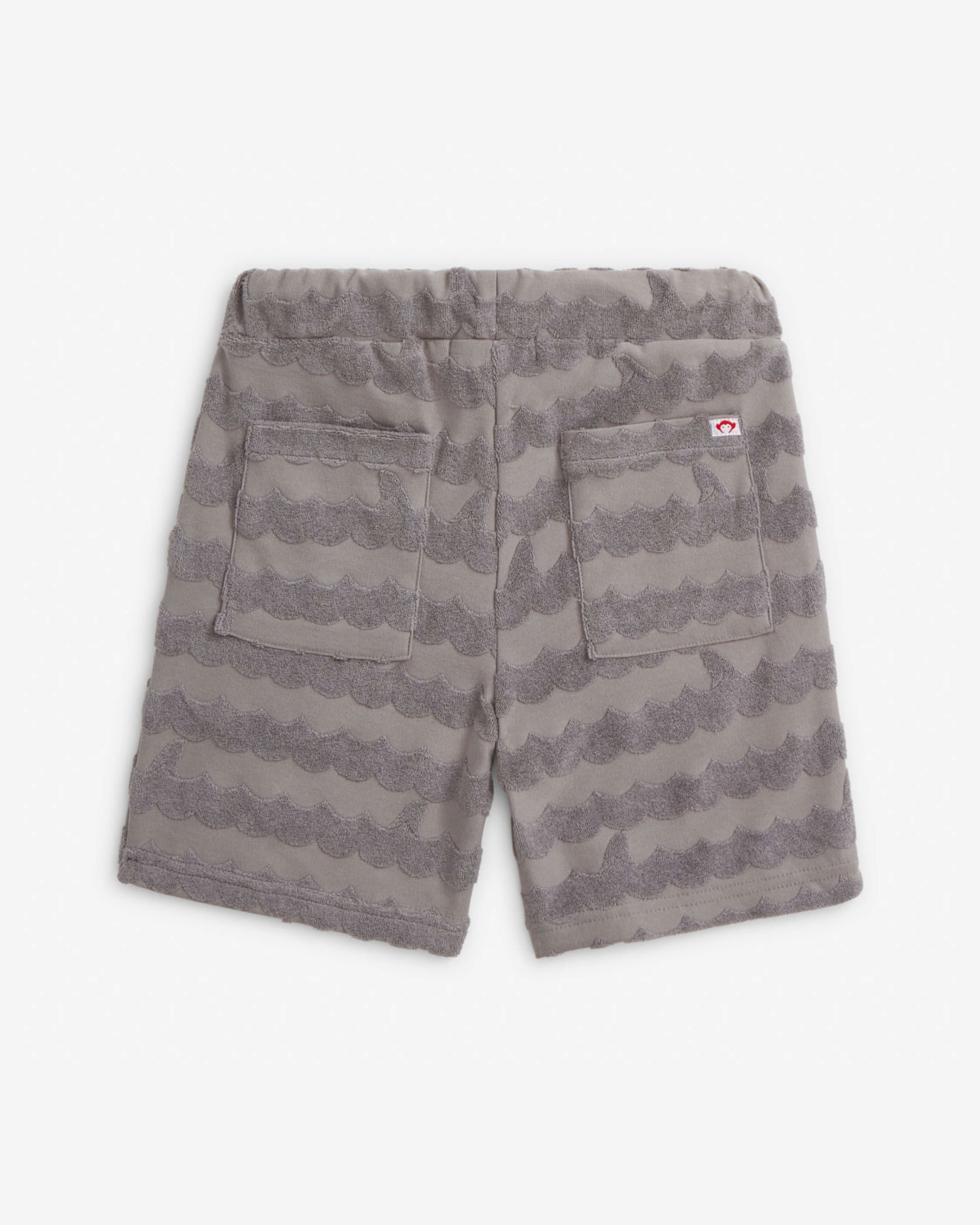 Back view of Grey Terry Resort Set shorts showcasing high quality kids clothing with textured pattern and pockets.