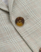Close-up of the Linen Oceanside Plaid Stretchy Mod Suit jacket with a detailed button and plaid design.