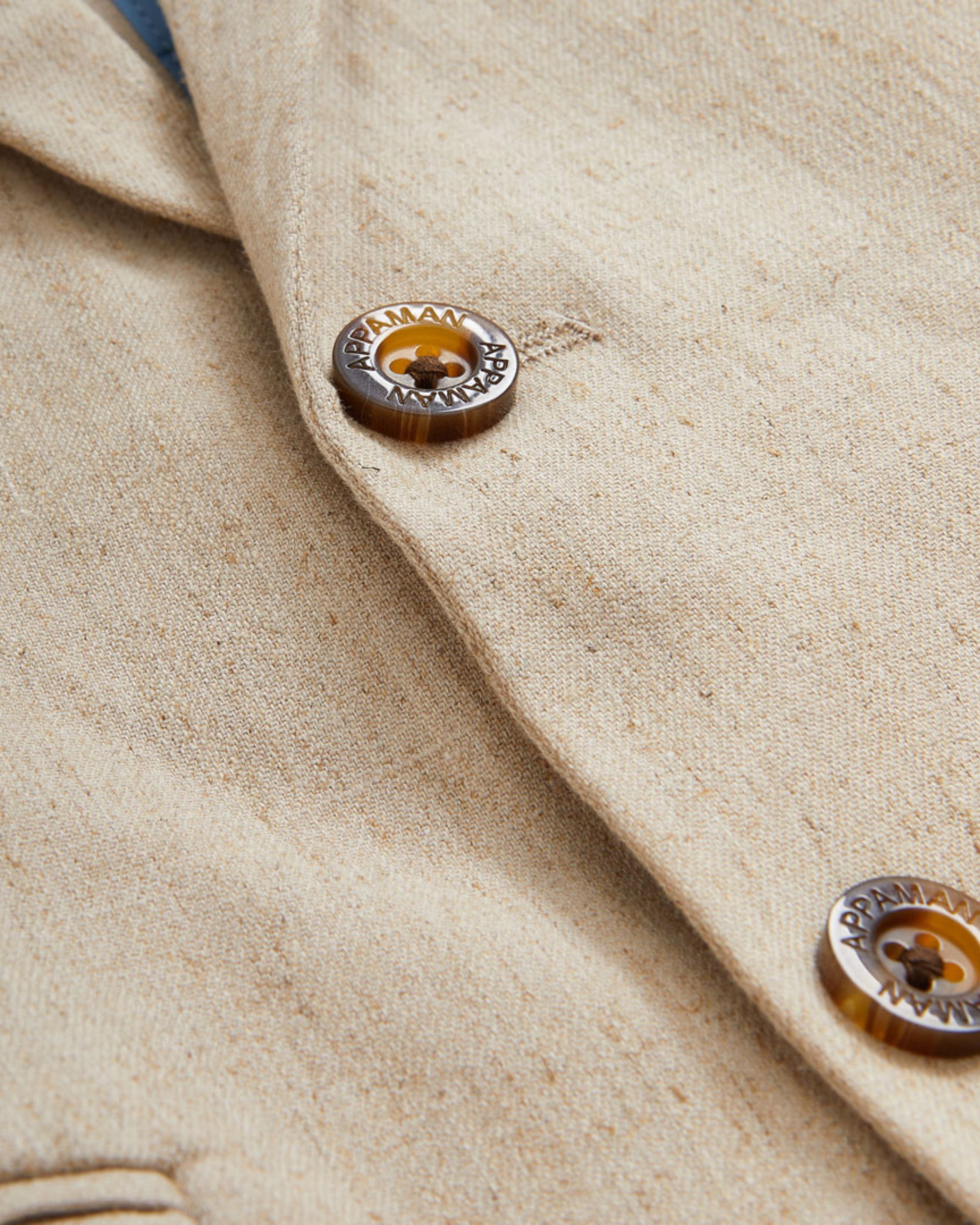 Close-up of buttons on Linen Parchment Stretchy Mod Suit jacket showcasing fine details and texture.