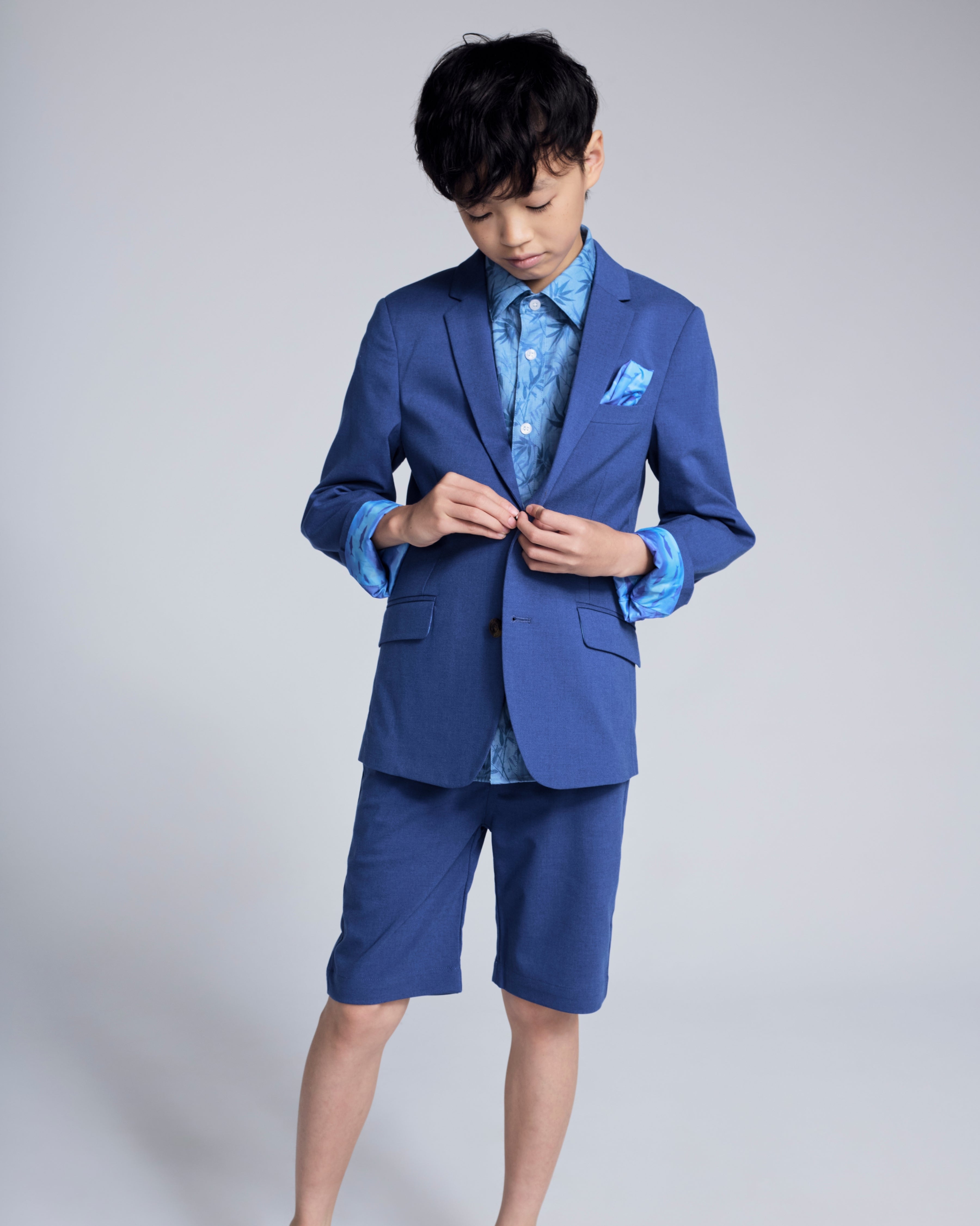 Boy wearing a Linen Canopy Blue Sports Jacket with shorts, showcasing stylish warm-weather fashion.