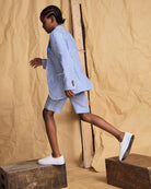 Linen Canopy Stripe Club Blazer worn with stylish shorts, showcasing a modern spring and summer look.
